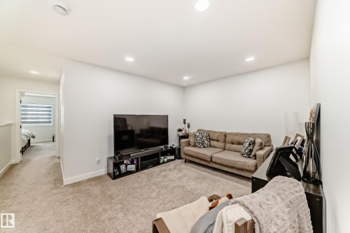 Carpeted living room featuring recessed lighting and baseboards - 3569 Erlanger Link, Edmonton, AB - Indoor