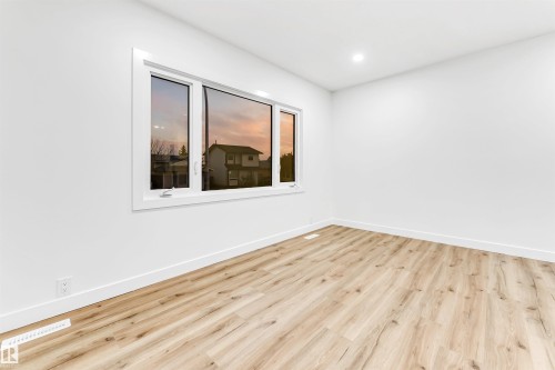Empty room with wood finished floors and recessed lighting - 4616 32 Avenue, Edmonton, AB - Indoor Photo Showing Other Room