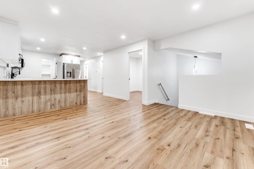 Unfurnished living room with light wood finished floors and recessed lighting - 4616 32 Avenue, Edmonton, AB - Indoor