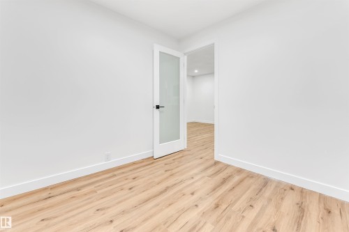 Spare room featuring baseboards and wood finished floors - 4616 32 Avenue, Edmonton, AB - Indoor Photo Showing Other Room