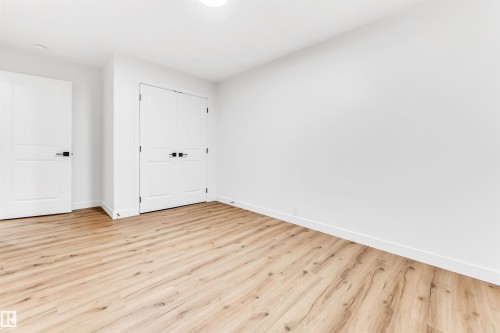 Unfurnished bedroom with light wood-style flooring and a closet - 4616 32 Avenue, Edmonton, AB - Indoor Photo Showing Other Room