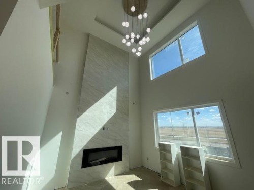 22 Owl Ridge Close, Fort Saskatchewan, AB - Indoor Photo Showing Other Room With Fireplace