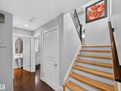 Stairs with hardwood / wood-style floors and baseboards - 1062 Tory Road, Edmonton, AB - Indoor Photo Showing Other Room