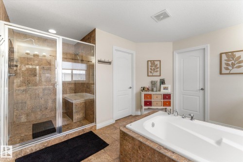 Full bathroom with a garden tub, a stall shower, light tile patterned floors, and vanity - 13 Heron Link, Spruce Grove, AB - Indoor Photo Showing Bathroom