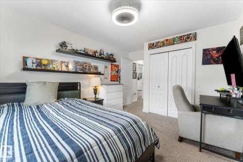 Bedroom with light carpet and a closet - 13 Heron Link, Spruce Grove, AB - Indoor Photo Showing Bedroom
