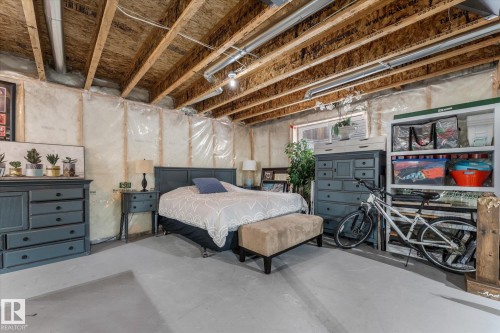 Bedroom with concrete flooring - 13 Heron Link, Spruce Grove, AB - Indoor Photo Showing Basement