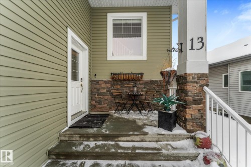 View of exterior entry featuring stone siding - 13 Heron Link, Spruce Grove, AB - Outdoor With Exterior