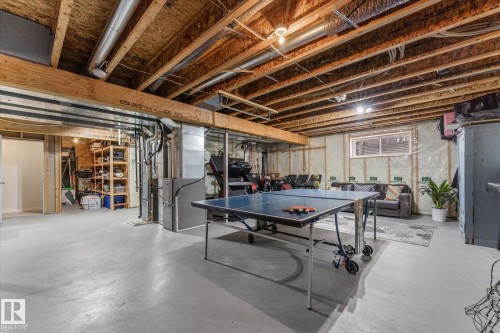 Recreation room featuring concrete flooring and heating unit - 13 Heron Link, Spruce Grove, AB - Indoor Photo Showing Basement