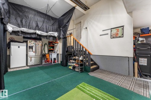 Below grade area with stainless steel fridge and white refrigerator - 13 Heron Link, Spruce Grove, AB - Indoor