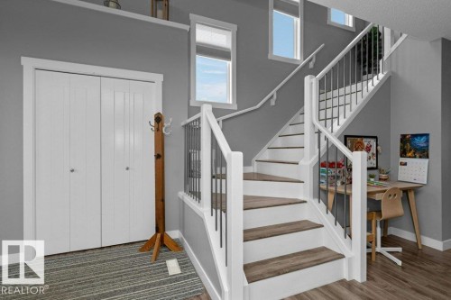 Stairs featuring baseboards and a high ceiling - 2607 20 Avenue, Edmonton, AB - Indoor Photo Showing Other Room