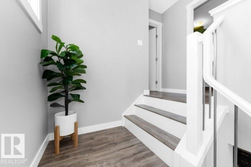 Stairs featuring wood finished floors and baseboards - 2607 20 Avenue, Edmonton, AB - Indoor Photo Showing Other Room