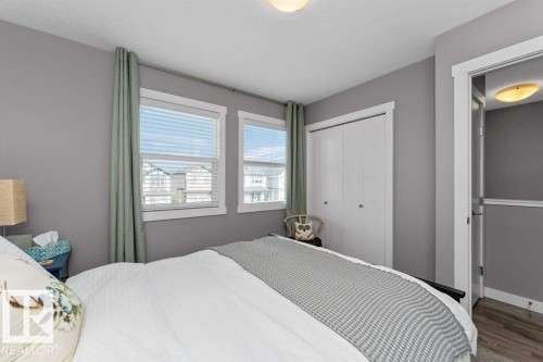 Bedroom featuring a closet, a textured ceiling, and wood finished floors - 2607 20 Avenue, Edmonton, AB - Indoor Photo Showing Bedroom