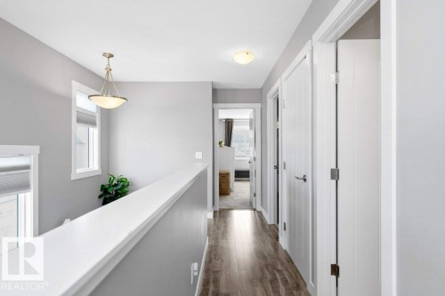 Hall featuring dark wood-style floors and an upstairs landing - 2607 20 Avenue, Edmonton, AB - Indoor Photo Showing Other Room
