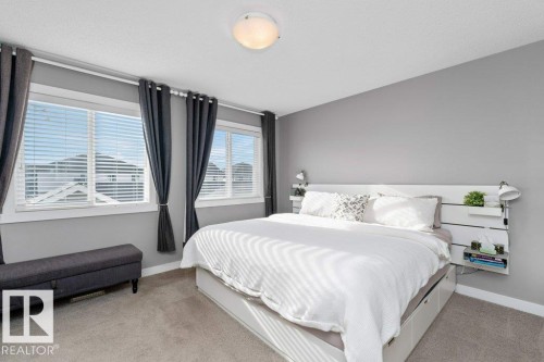 Bedroom with light carpet and baseboards - 2607 20 Avenue, Edmonton, AB - Indoor Photo Showing Bedroom