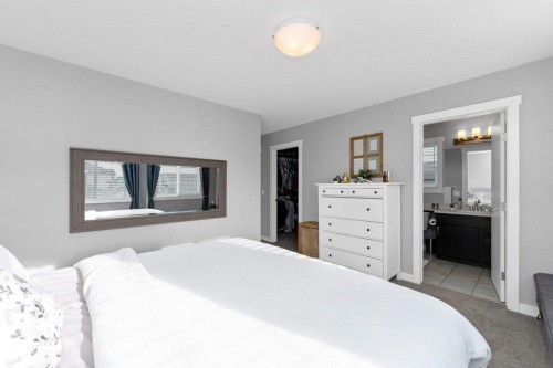 Bedroom with a spacious closet, carpet floors, and ensuite bath - 2607 20 Avenue, Edmonton, AB - Indoor Photo Showing Bedroom
