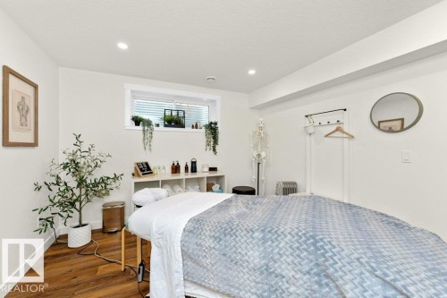 Bedroom with wood finished floors, recessed lighting, and radiator - 2607 20 Avenue, Edmonton, AB - Indoor Photo Showing Bedroom