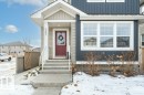 Snow covered property entrance with board and batten siding and a gate - 2607 20 Avenue, Edmonton, AB  - Outdoor 