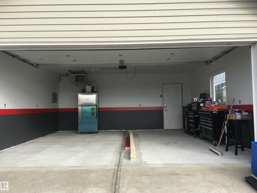 Garage featuring freestanding refrigerator, a heating unit, and electric panel - 2607 20 Avenue, Edmonton, AB - Indoor Photo Showing Garage