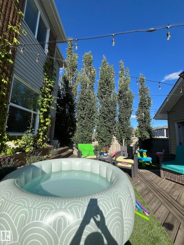 Wooden terrace with a fenced backyard and an outdoor hot tub - 2607 20 Avenue, Edmonton, AB - Outdoor