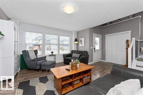 Living room with wood finished floors and a textured ceiling - 2607 20 Avenue, Edmonton, AB - Indoor Photo Showing Living Room