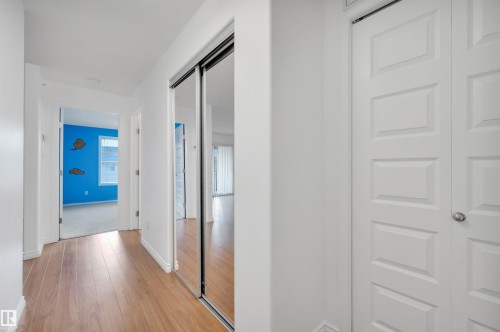Hall featuring baseboards and light wood finished floors - 422 7909 71 Street, Edmonton, AB - Indoor Photo Showing Other Room