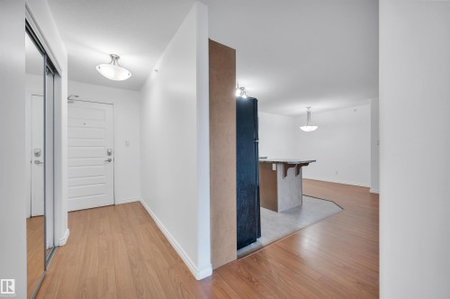 Corridor with light wood-type flooring and baseboards - 422 7909 71 Street, Edmonton, AB - Indoor Photo Showing Other Room