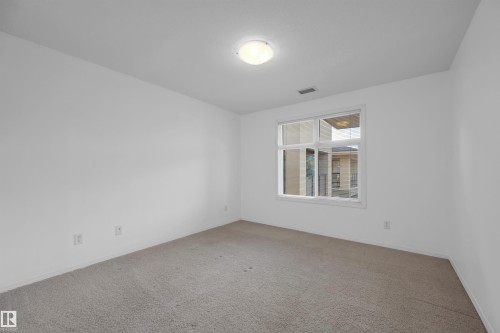 Carpeted spare room with baseboards - 422 7909 71 Street, Edmonton, AB - Indoor Photo Showing Other Room
