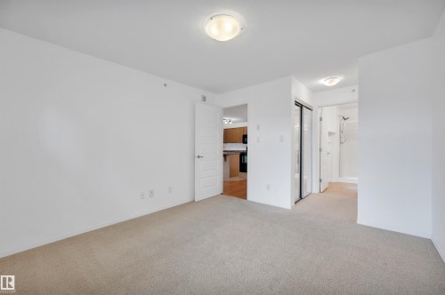 Unfurnished bedroom with light colored carpet, a closet, and ensuite bath - 422 7909 71 Street, Edmonton, AB - Indoor Photo Showing Other Room