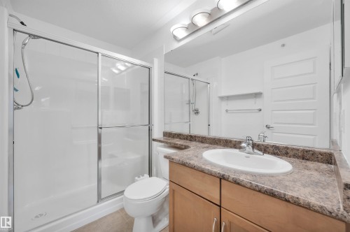 Bathroom featuring vanity, a stall shower, and light tile patterned floors - 422 7909 71 Street, Edmonton, AB - Indoor Photo Showing Bathroom