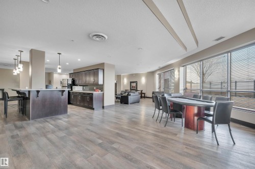 Dining area featuring light wood-style flooring, recessed lighting, and a textured ceiling - 422 7909 71 Street, Edmonton, AB - Indoor Photo Showing Other Room