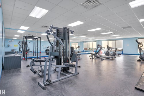 Workout area with a paneled ceiling - 422 7909 71 Street, Edmonton, AB - Indoor Photo Showing Gym Room