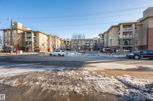 View of asphalt road with street lights - 422 7909 71 Street, Edmonton, AB - Outdoor With Balcony With Facade