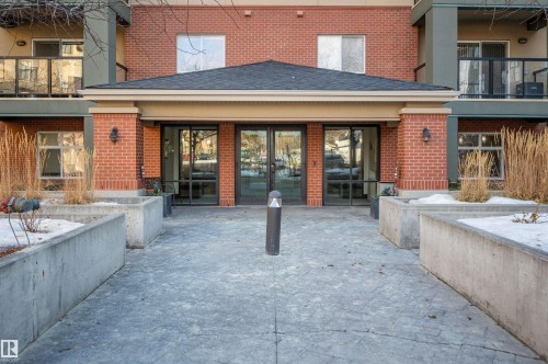 Back of house featuring a balcony, brick siding, and a shingled roof - 422 7909 71 Street, Edmonton, AB - Outdoor With Balcony With Exterior