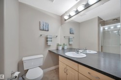 Full bathroom with vanity, a stall shower, a textured ceiling, and light tile patterned floors - 