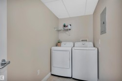Laundry area with washer and clothes dryer and electric panel - 