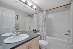 Bathroom featuring vanity, shower / bathtub combination with curtain, and a textured ceiling - 