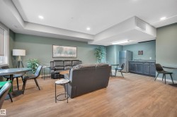 Living area with light wood-style flooring and recessed lighting - 