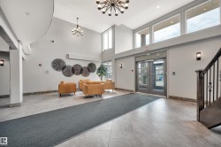 Lobby with a high ceiling and recessed lighting - 