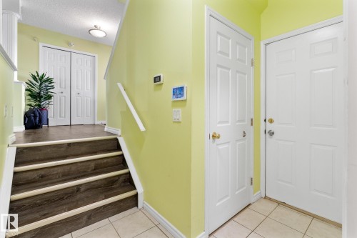 Entryway featuring light tile patterned floors and a textured ceiling - 13148 151 Avenue, Edmonton, AB - Indoor Photo Showing Other Room