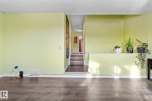 Foyer entrance with wood finished floors and a textured ceiling - 13148 151 Avenue, Edmonton, AB - Indoor Photo Showing Other Room
