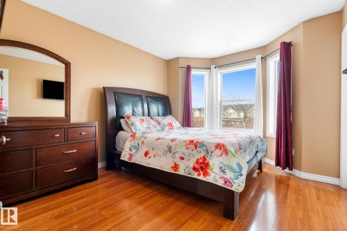 Bedroom featuring light wood-style flooring and a textured ceiling - 13148 151 Avenue, Edmonton, AB - Indoor Photo Showing Bedroom