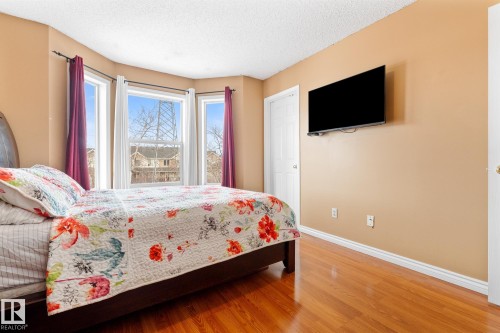 Bedroom featuring wood finished floors and a textured ceiling - 13148 151 Avenue, Edmonton, AB - Indoor Photo Showing Bedroom