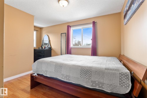 Bedroom with wood finished floors and a textured ceiling - 13148 151 Avenue, Edmonton, AB - Indoor Photo Showing Bedroom