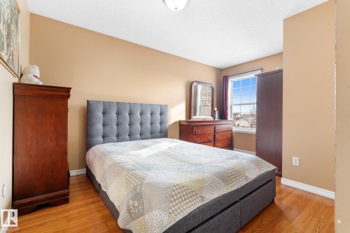 Bedroom with light wood-style flooring and a textured ceiling - 13148 151 Avenue, Edmonton, AB - Indoor Photo Showing Bedroom