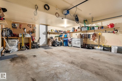 Garage featuring a workshop area and a garage door opener - 13148 151 Avenue, Edmonton, AB - Indoor Photo Showing Garage