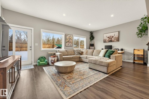 Living room with dark wood-style floors and recessed lighting - 74 Royal Street, St. Albert, AB - Indoor Photo Showing Living Room