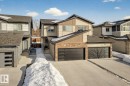View of front facade featuring concrete driveway, stone siding, a residential view, and board and batten siding - 74 Royal Street, St. Albert, AB  - Outdoor 