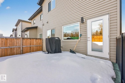 Exterior space featuring wood walls, a high ceiling, access to exterior, and multiple windows - 74 Royal Street, St. Albert, AB - Outdoor With Exterior