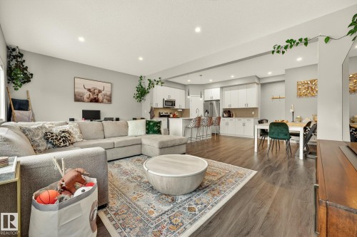 Living room featuring dark wood-style floors and recessed lighting - 74 Royal Street, St. Albert, AB - Indoor Photo Showing Living Room