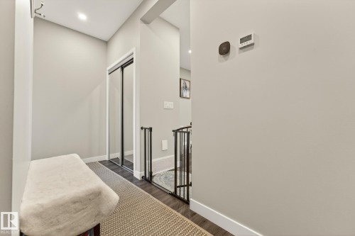 Hallway featuring dark wood-style floors, recessed lighting, and an upstairs landing - 74 Royal Street, St. Albert, AB - Indoor Photo Showing Other Room